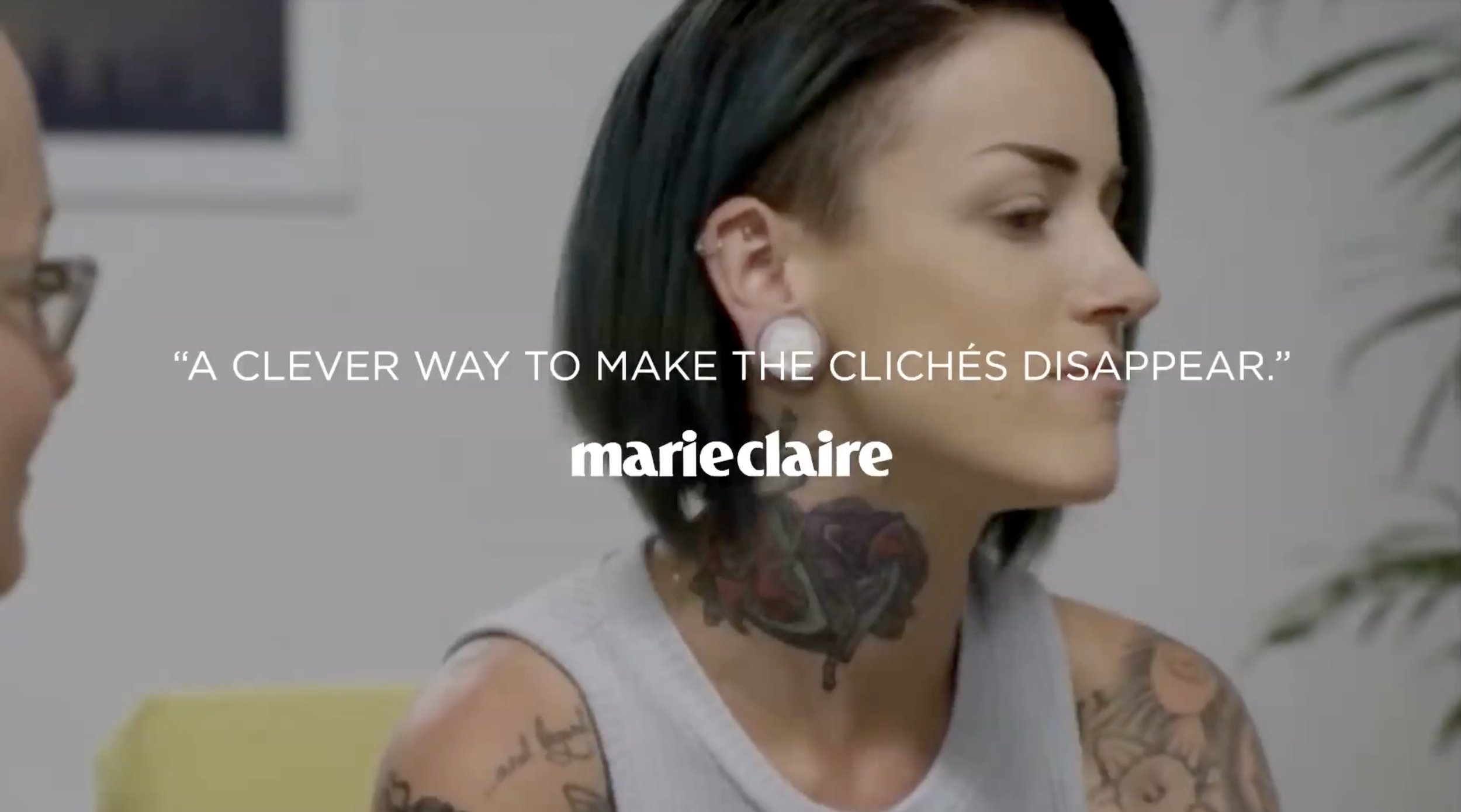 Side view of a woman with dark, short, asymmetric hair and tattoos on her shoulder and neck, sitting in a consultation room, with a quote overlayed that reads 'A clever way to make the clichés disappear.' Marie Claire logo.