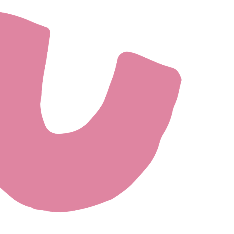 Close-up of a pink object with rounded edges and a black background.