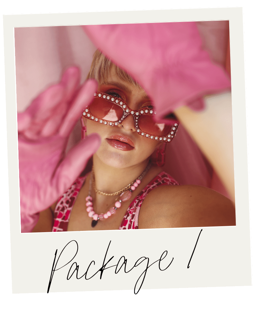 A woman dressed in pink, wearing pink gloves, pink sunglasses with rhinestones, pink jewelry, and a pink patterned top, taking a close-up selfie with a pink flower partially covering her face. The word "Package!" is written in cursive at the bottom.