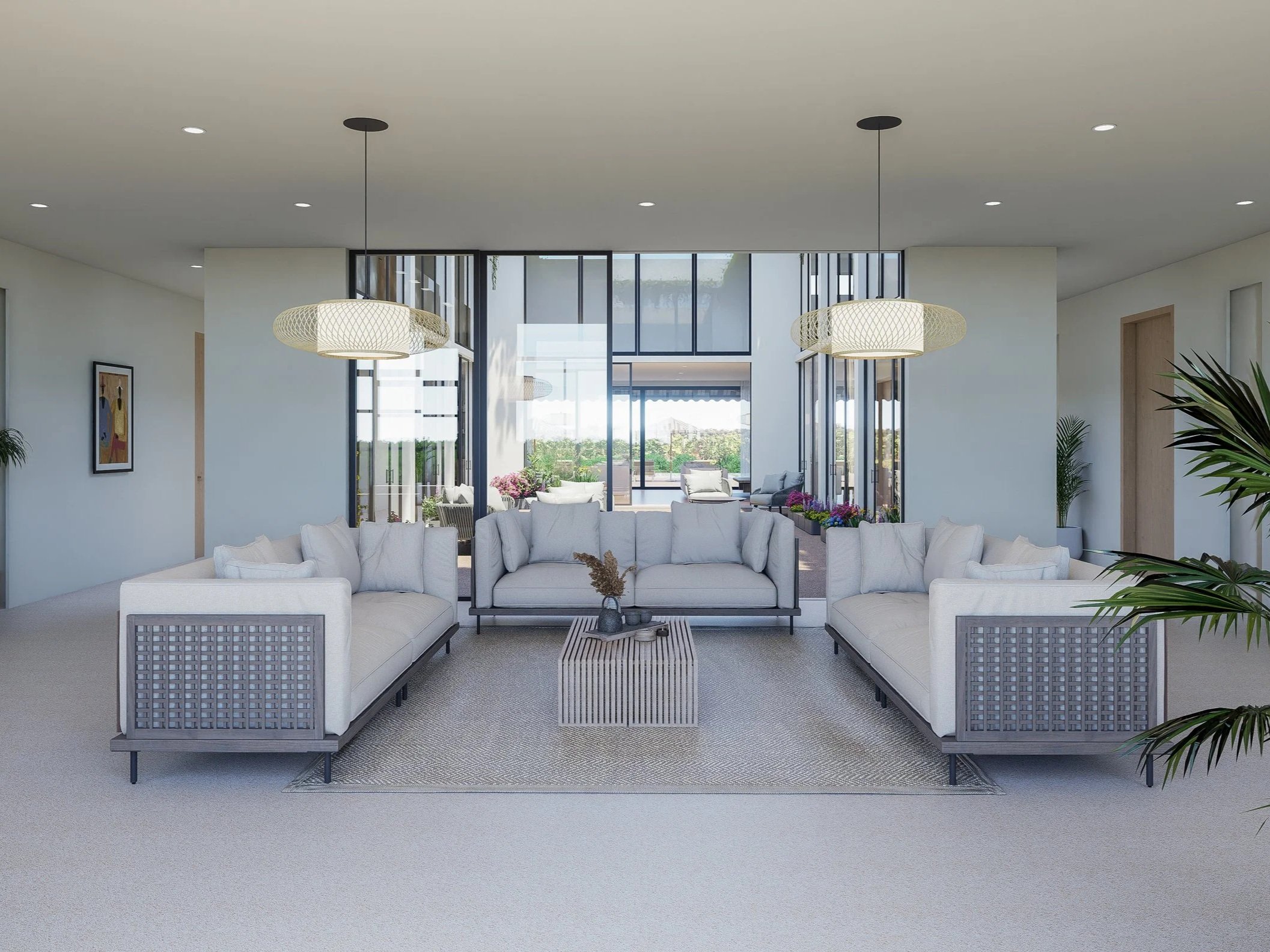 Modern living room with white sofas, a small striped coffee table, and large windows showing a patio with outdoor furniture and greenery.