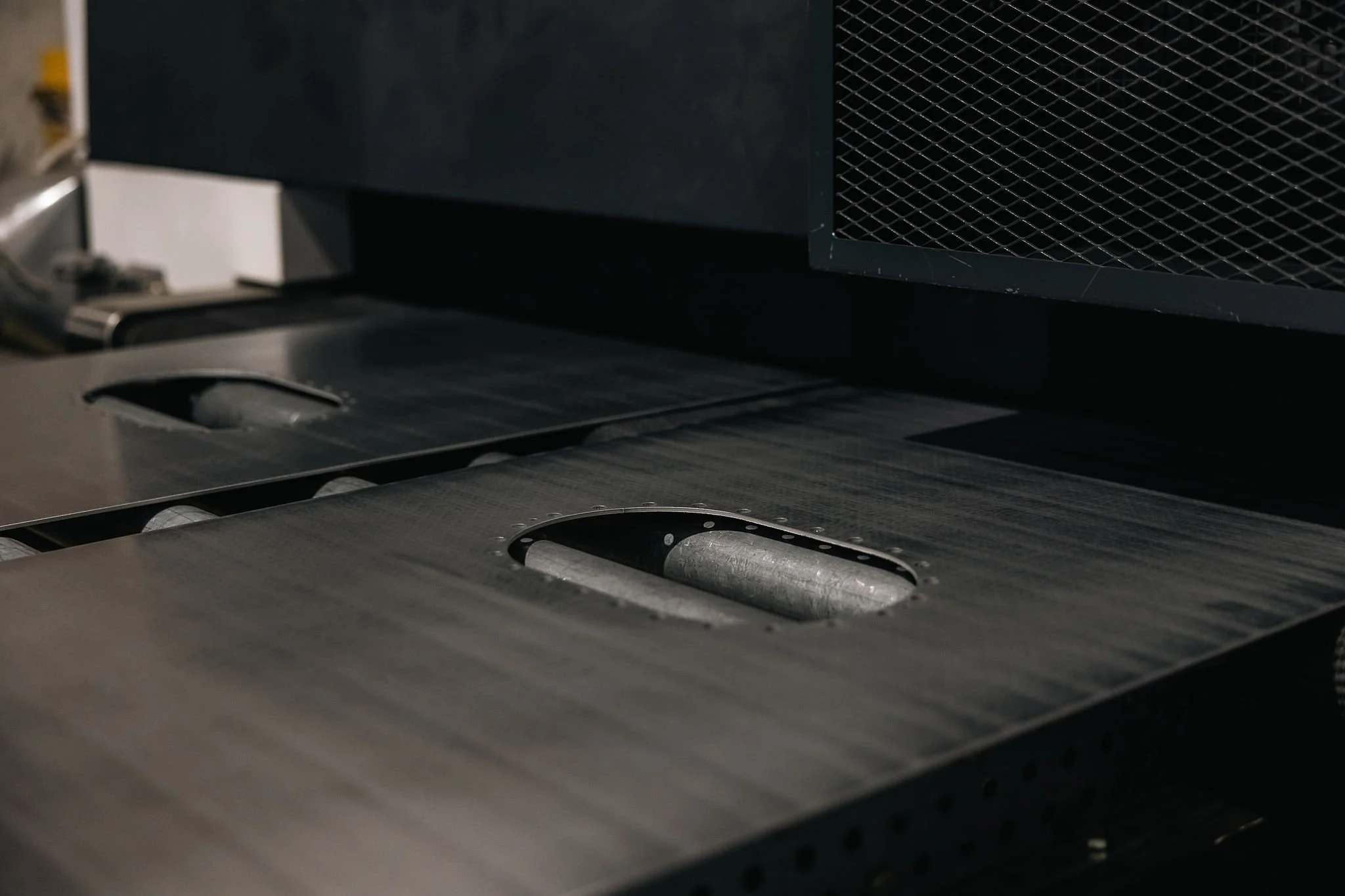 Metallikomponentin viimeistelyä reunaa hiomalla.