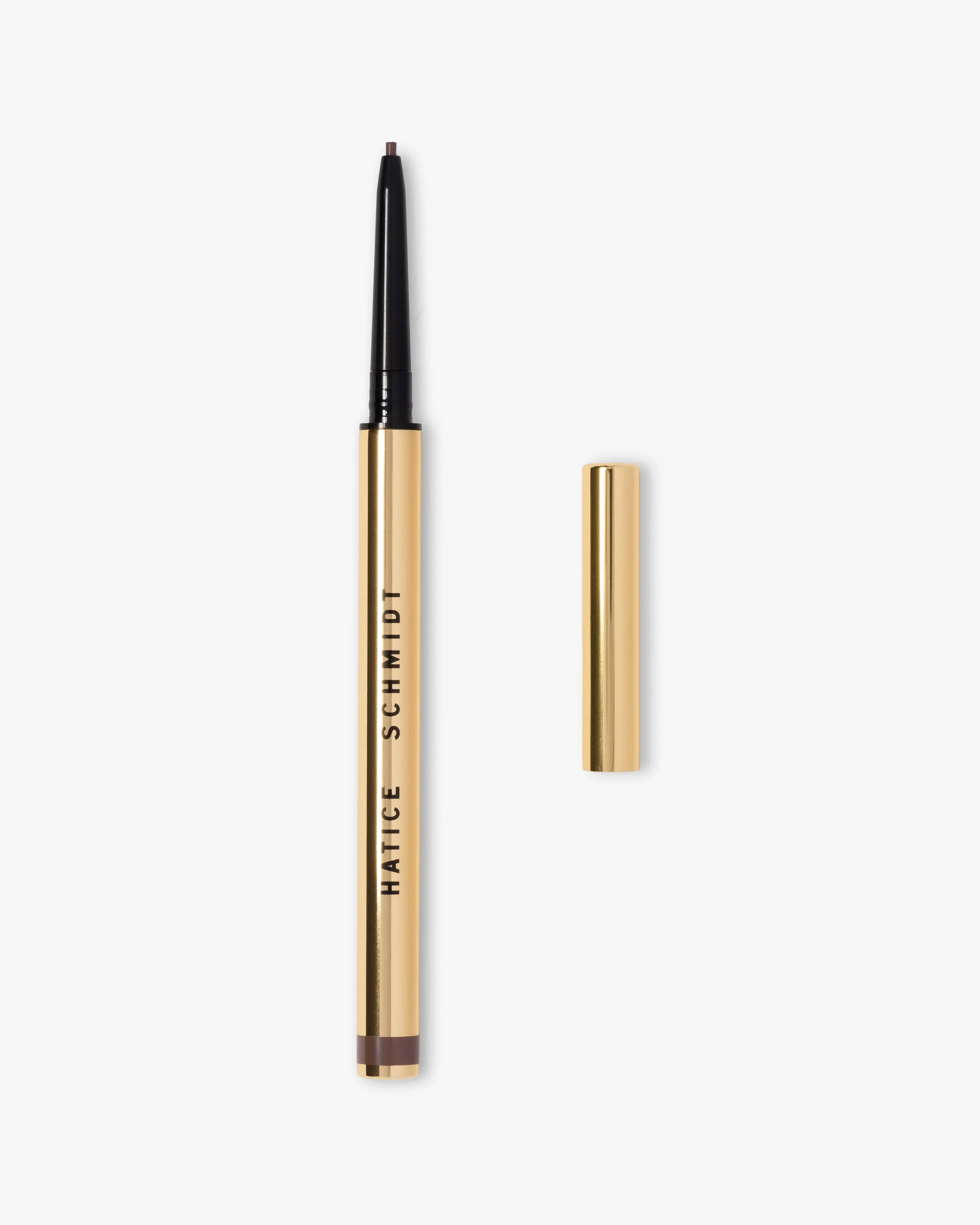 A gold and black eyeliner pen with its cap removed, lying on a white background.