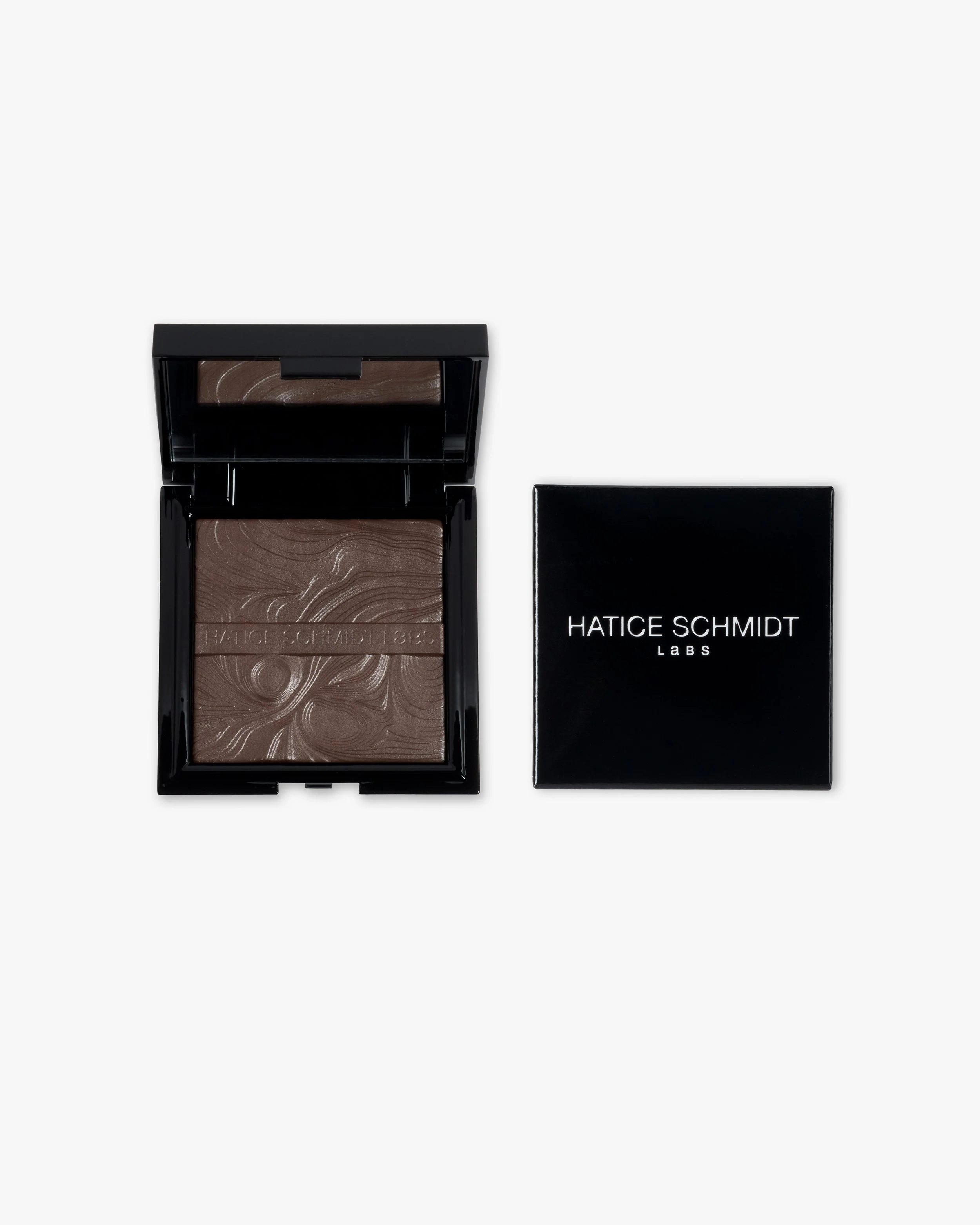 A compact makeup blush with a marble pattern in a black case, placed next to a black box labeled HATICE SCHMIDT LABS.