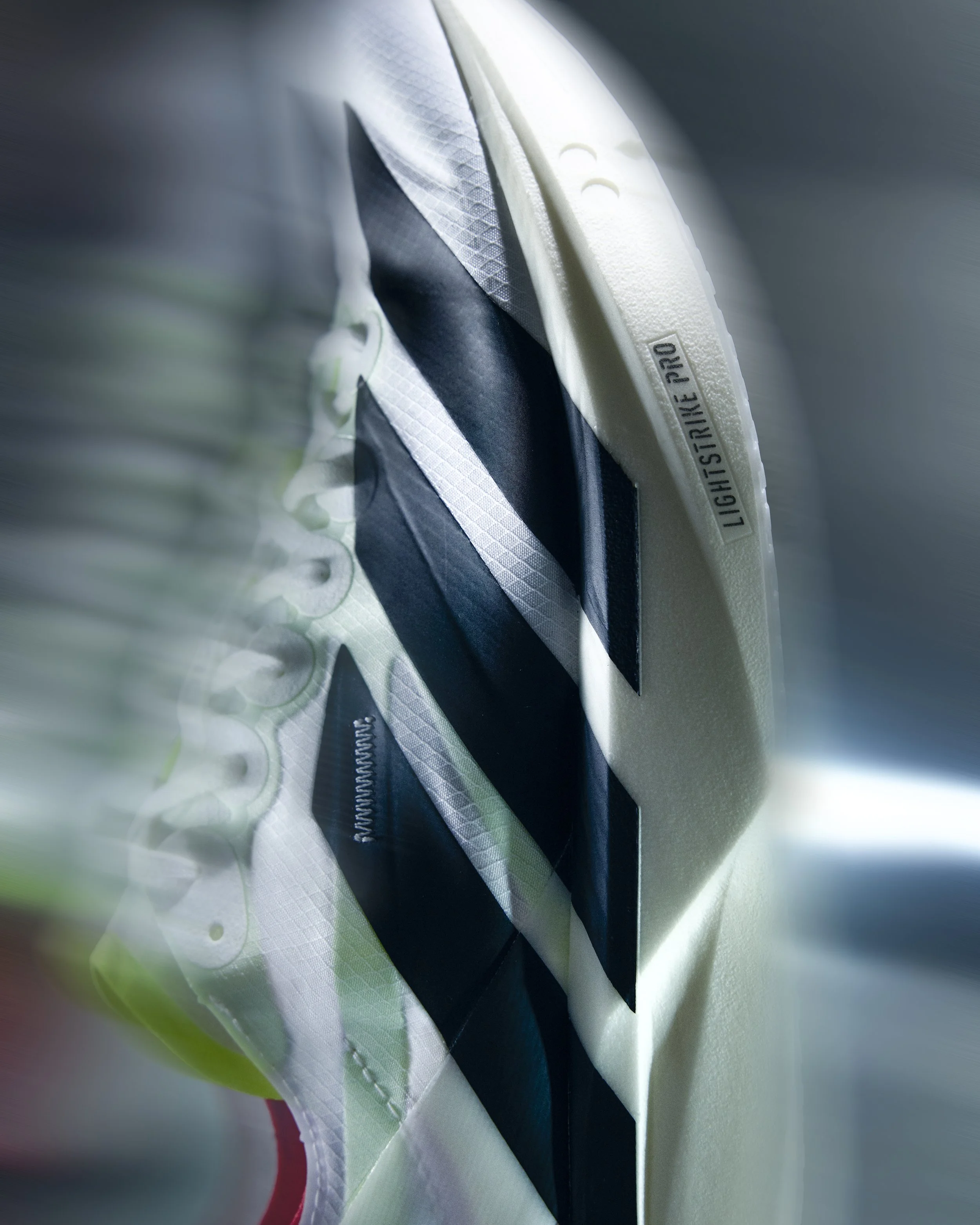 Close-up of the side of a Nike Lightstrike Pro athletic shoe showing part of the outsole and side panel.