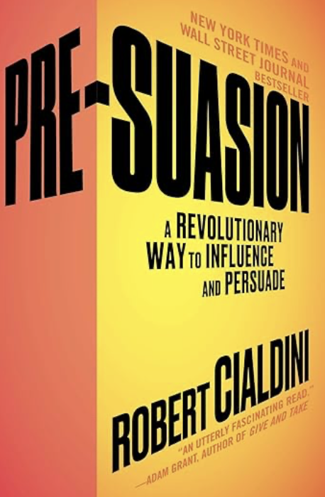 Book cover of 'Pre-Suasion' by Robert Cialdini, showcasing title and author, with a yellow background and bold black and red text.