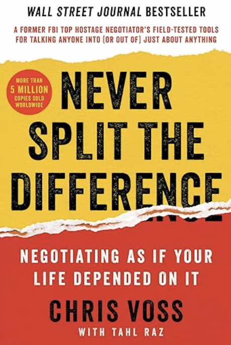 Cover of the book "Never Split the Difference" by Chris Voss with Tahl Raz, featuring a yellow and red background, black bold text, and a torn paper design.