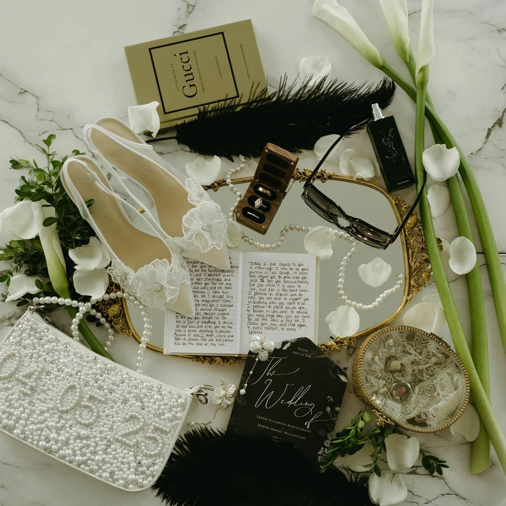 Wedding flat lay featuring sentimental bridal details and invitation suite at an Atlanta wedding designed by Port Town Collective