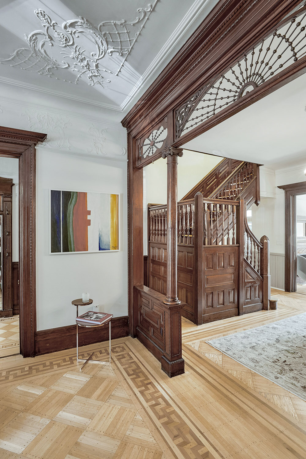 View of the front and middle parlor with original woodwork and hardwood floors restored