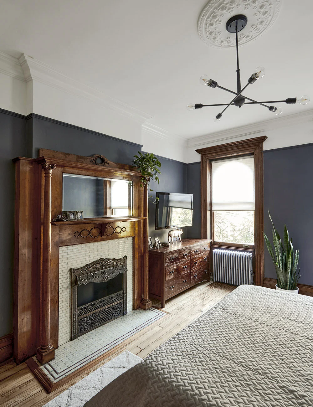Master bedroom with the original fireplace mantle and tile.