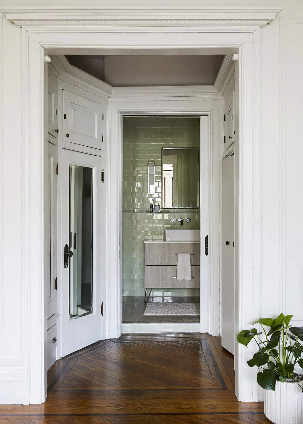 The green ceramic tile at the master bathroom adds a splash of color to the otherwise neutral (mostly while) interior