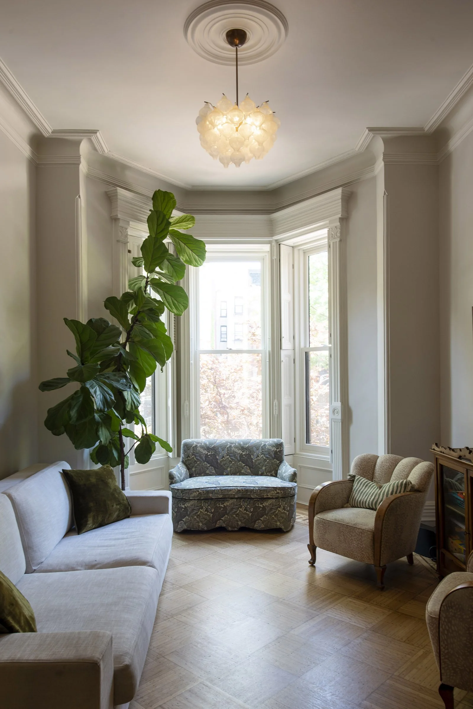 Living room boasts restored and refinished bay window and great southern light.