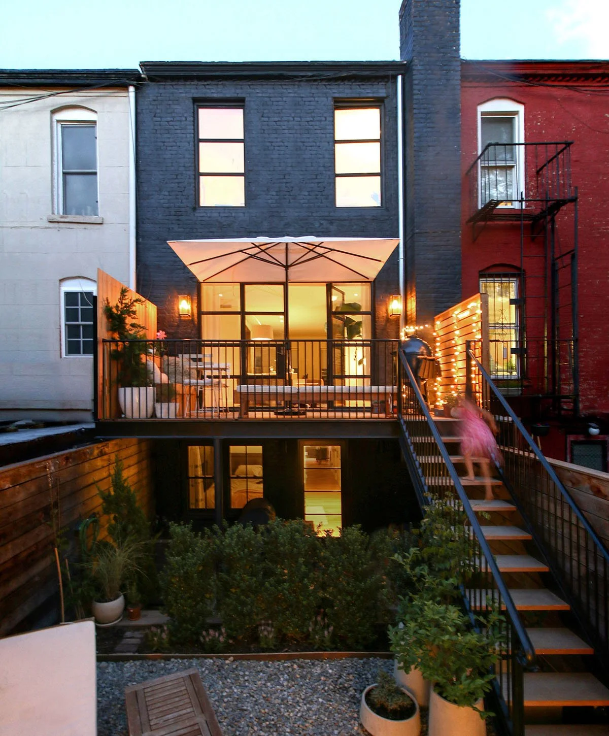unbelievable transformation of a landmarked townhome in South Slope, Brooklyn, with wide doors at the parlor level opening up to the backyard