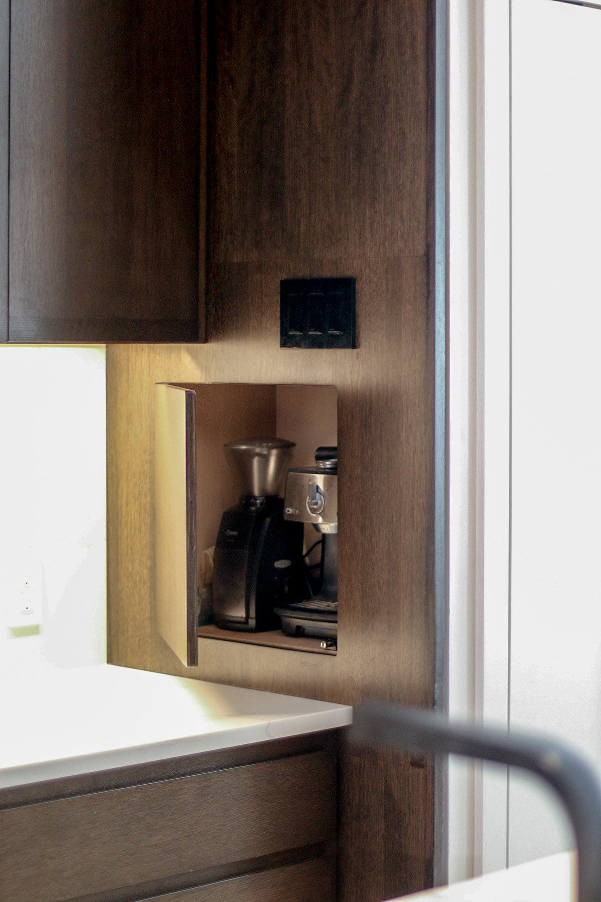 Kitchen with a coffee nook, featuring a built-in cabinet with an espresso machine and coffee grinder.