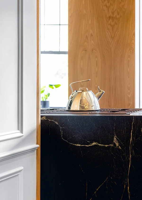 The kitchen island is wrapped in soapstone