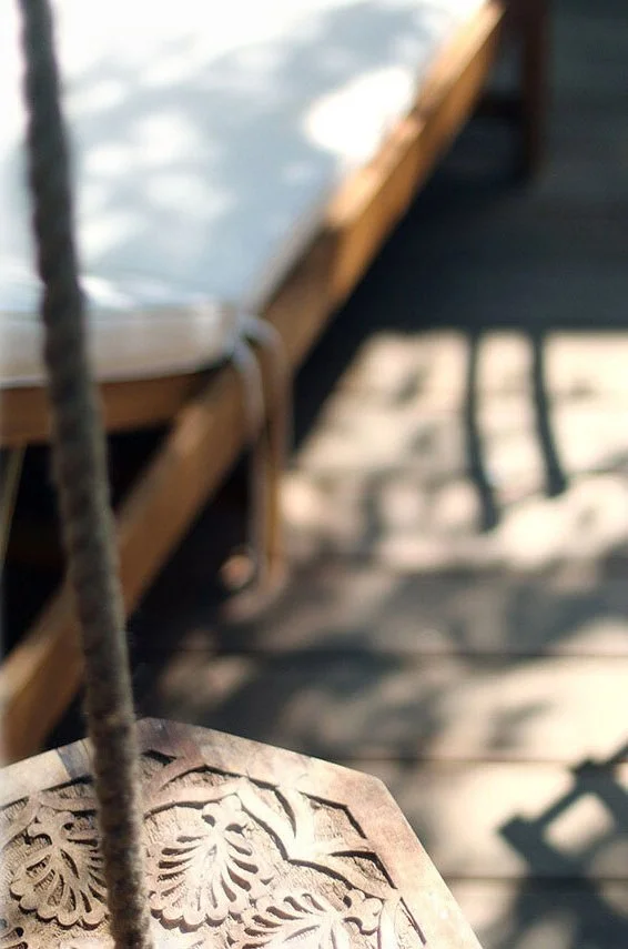 And a playful wooden swing hung from the large tree.