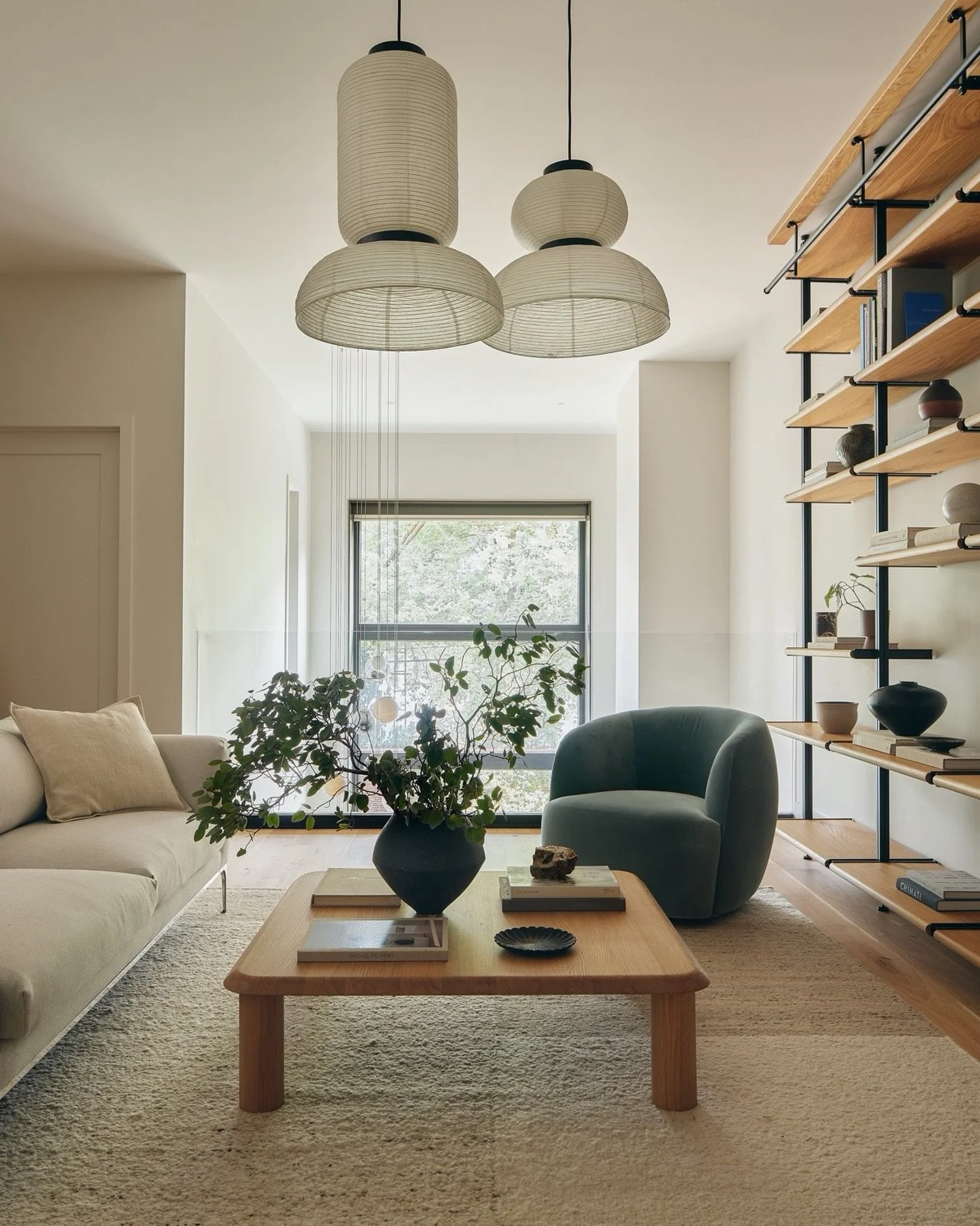 A quiet moment in the second-floor library at Java Haus &mdash; perched above the double-height kitchen, washed in south light from the oversized window at the back. A Passive House in Greenpoint, Brooklyn.

Furnishings: Custom bookcase by @rakksselv
