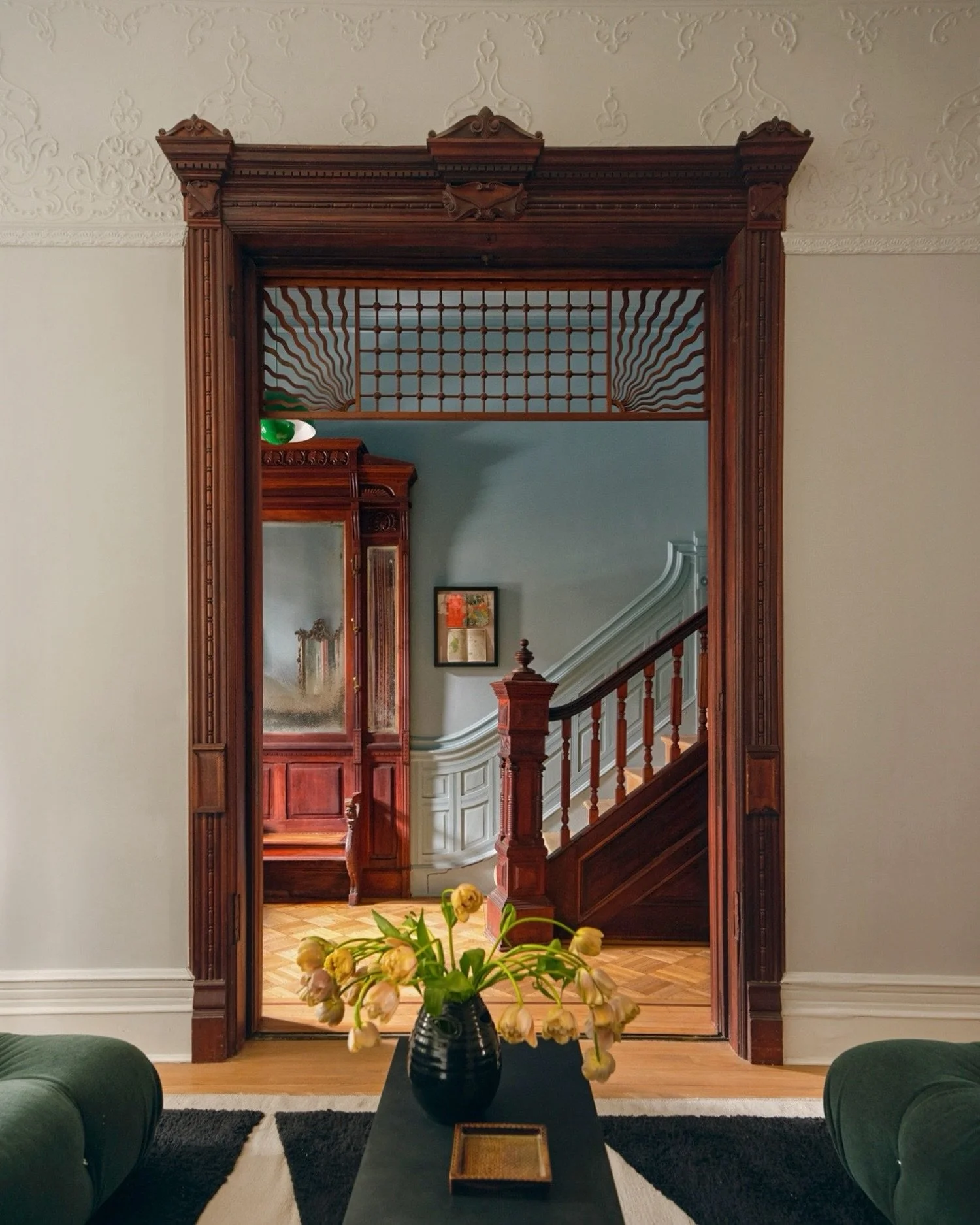 Through the pocket doors. Late 19th-century original millwork, parquet floors, and a stair that&rsquo;s been waiting a century to be seen like this. 
The Oculus House, in Park Slope, Brooklyn - as featured in @nymag&rsquo;s latest issue. Link in bio.