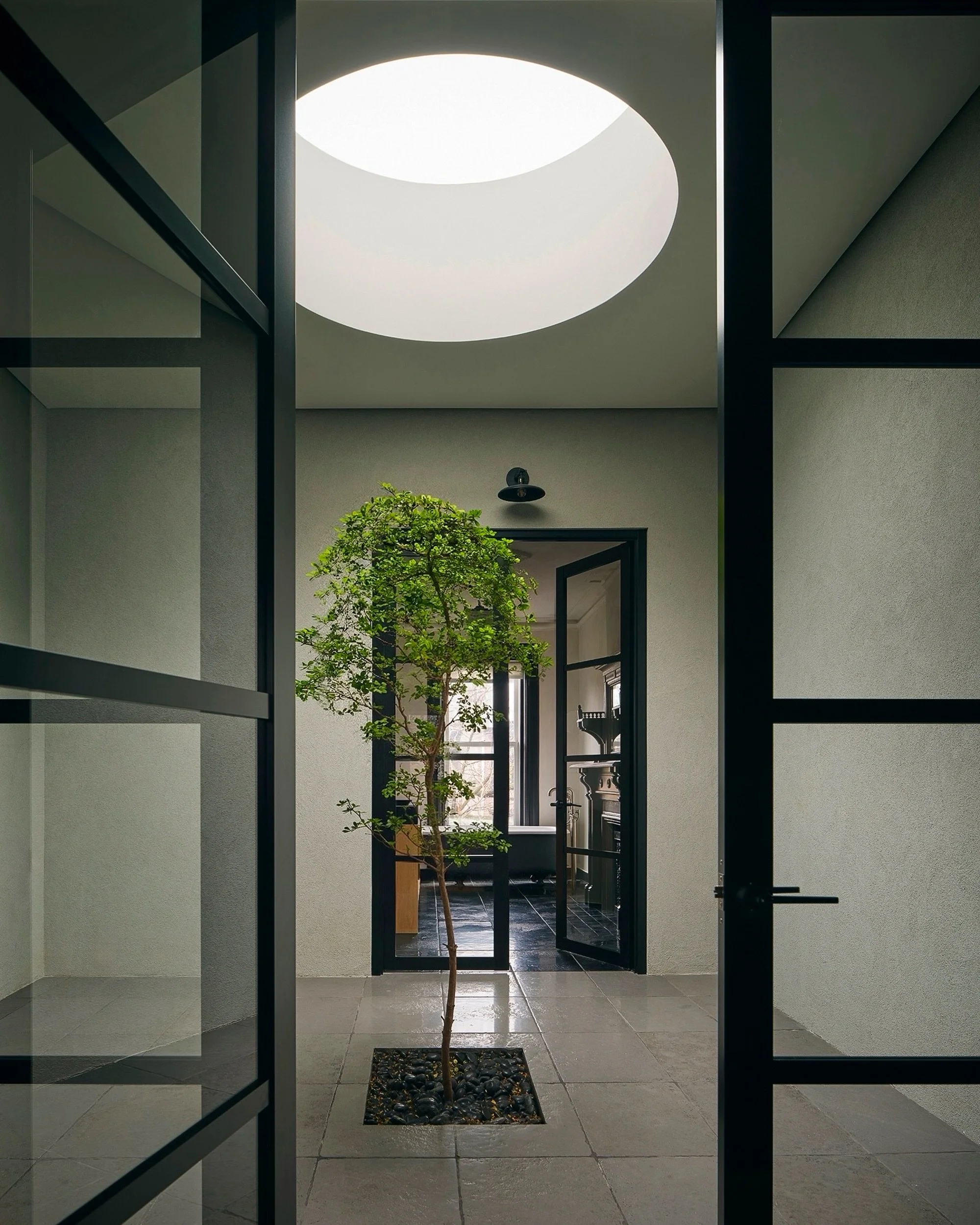 A moment beneath the oculus.
.
Designed to bring daylight deep into the center of this historic Brooklyn brownstone, the 6-foot wide, triple-glazed, operable circular skylight transforms what might otherwise have been a transitional space into one of