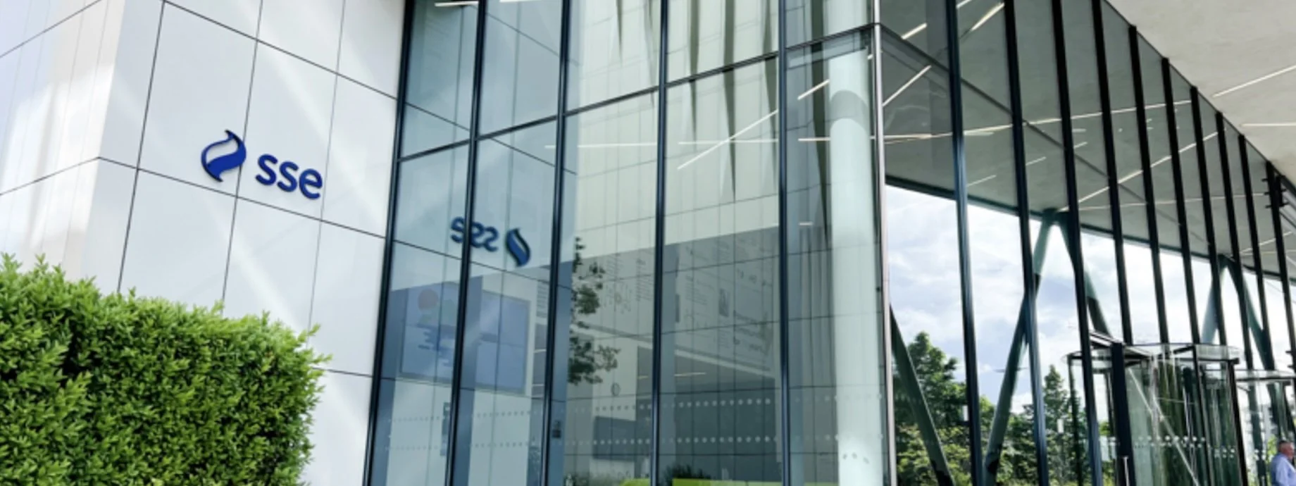 Modern office building with glass walls and the SSE logo on the exterior.
