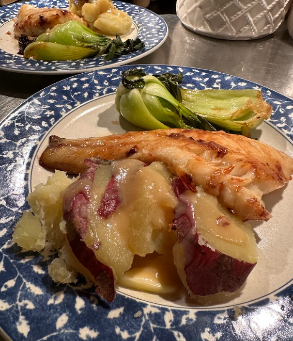 Plate with cooked salmon, mashed sweet potatoes with red skin, and roasted bok choy
