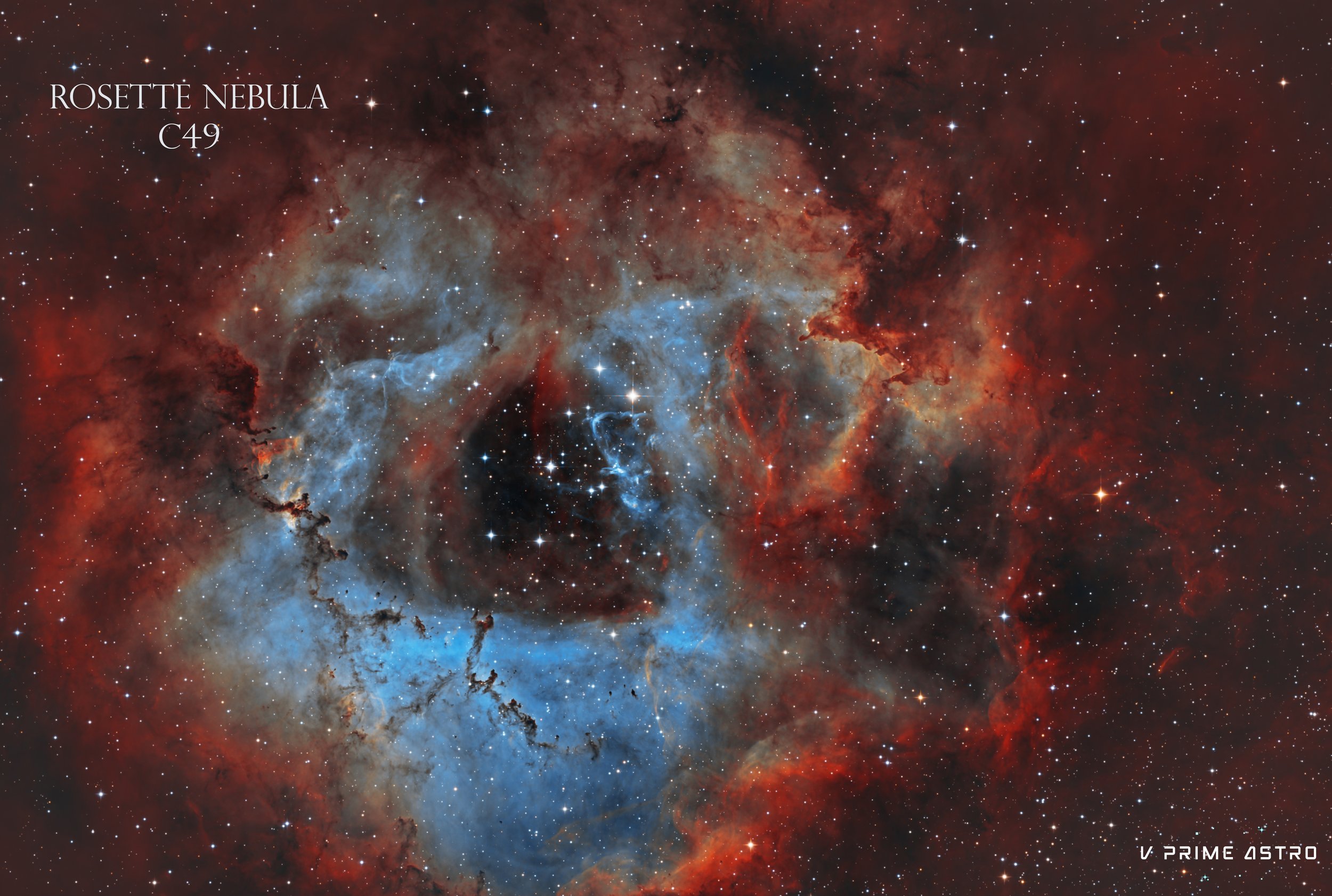 A colorful image of the Rosette Nebula with intricate patterns of blue, red, and tan gas clouds and numerous stars scattered across space.  