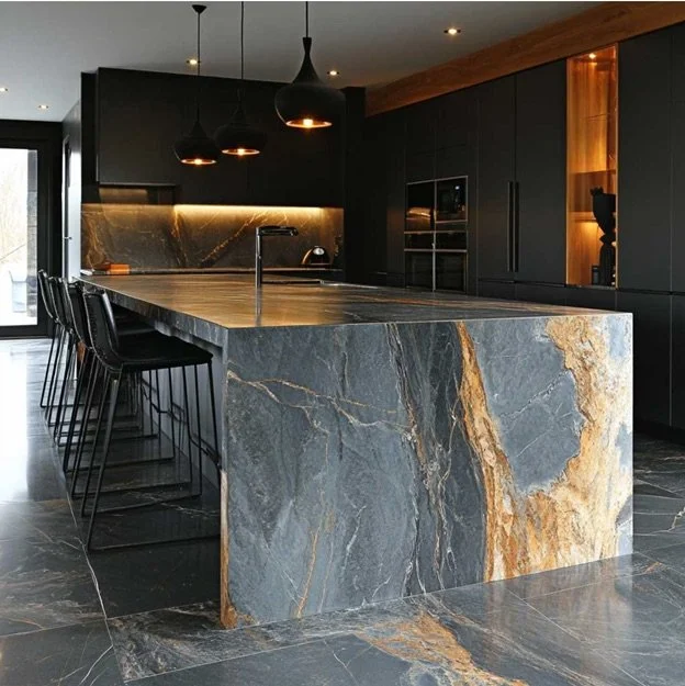 Modern kitchen with a large marble island, black cabinets, black pendant lights, and a black backsplash with under-cabinet lighting.