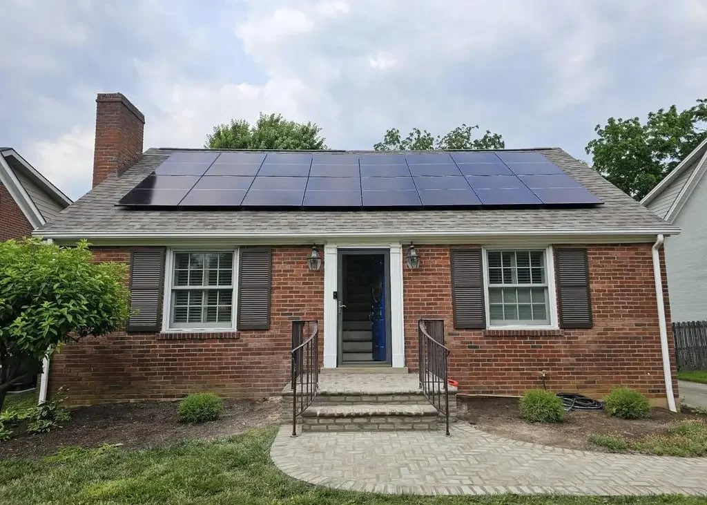 Solar panels on top of residential brick home.
