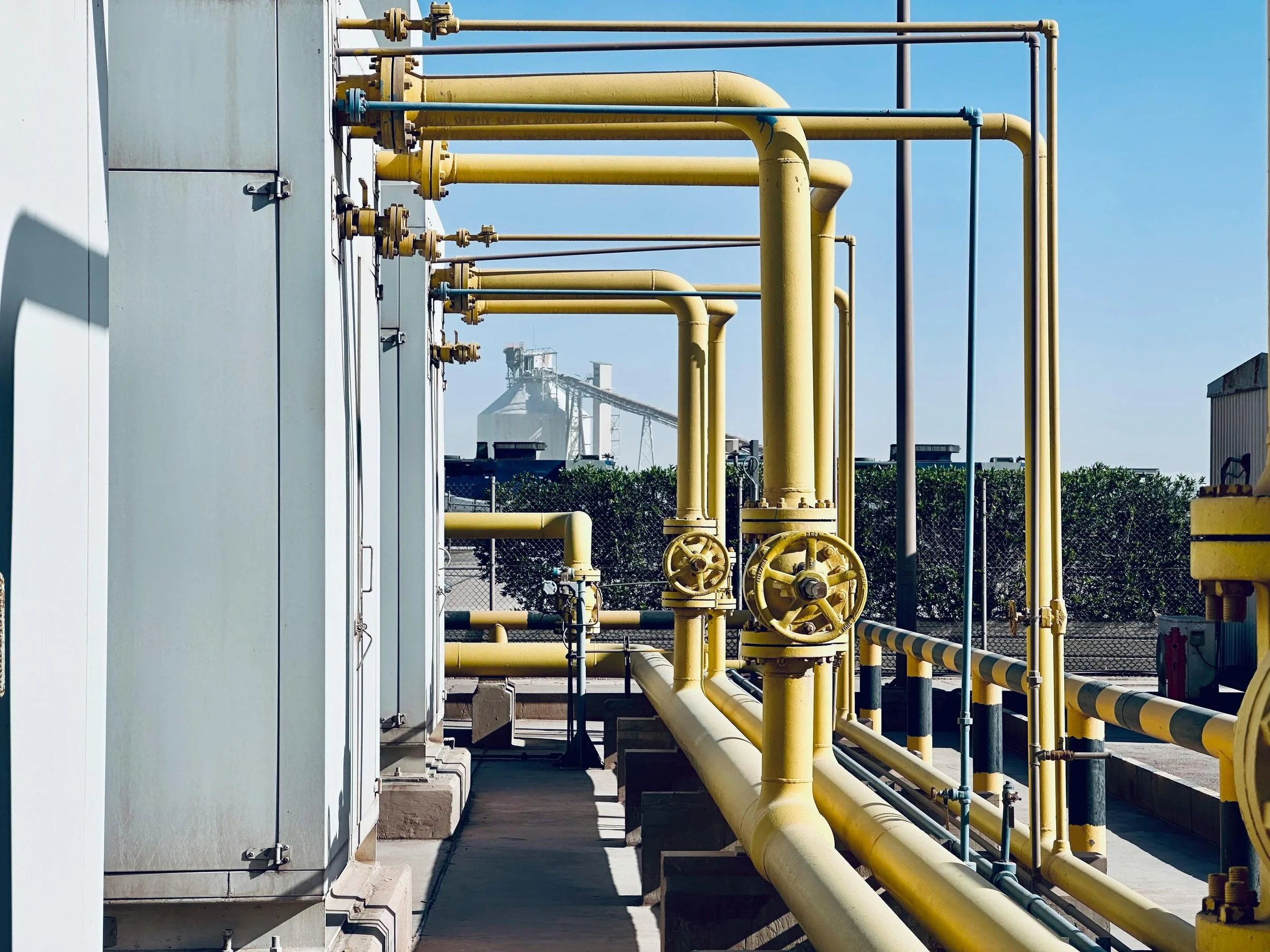 A natural gas plant with multiple yellow gas pipes.