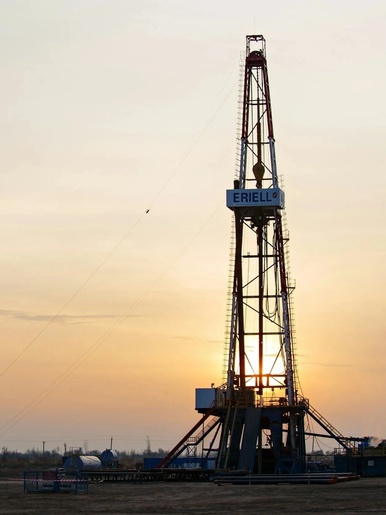 An oil drill illuminated by the sun.