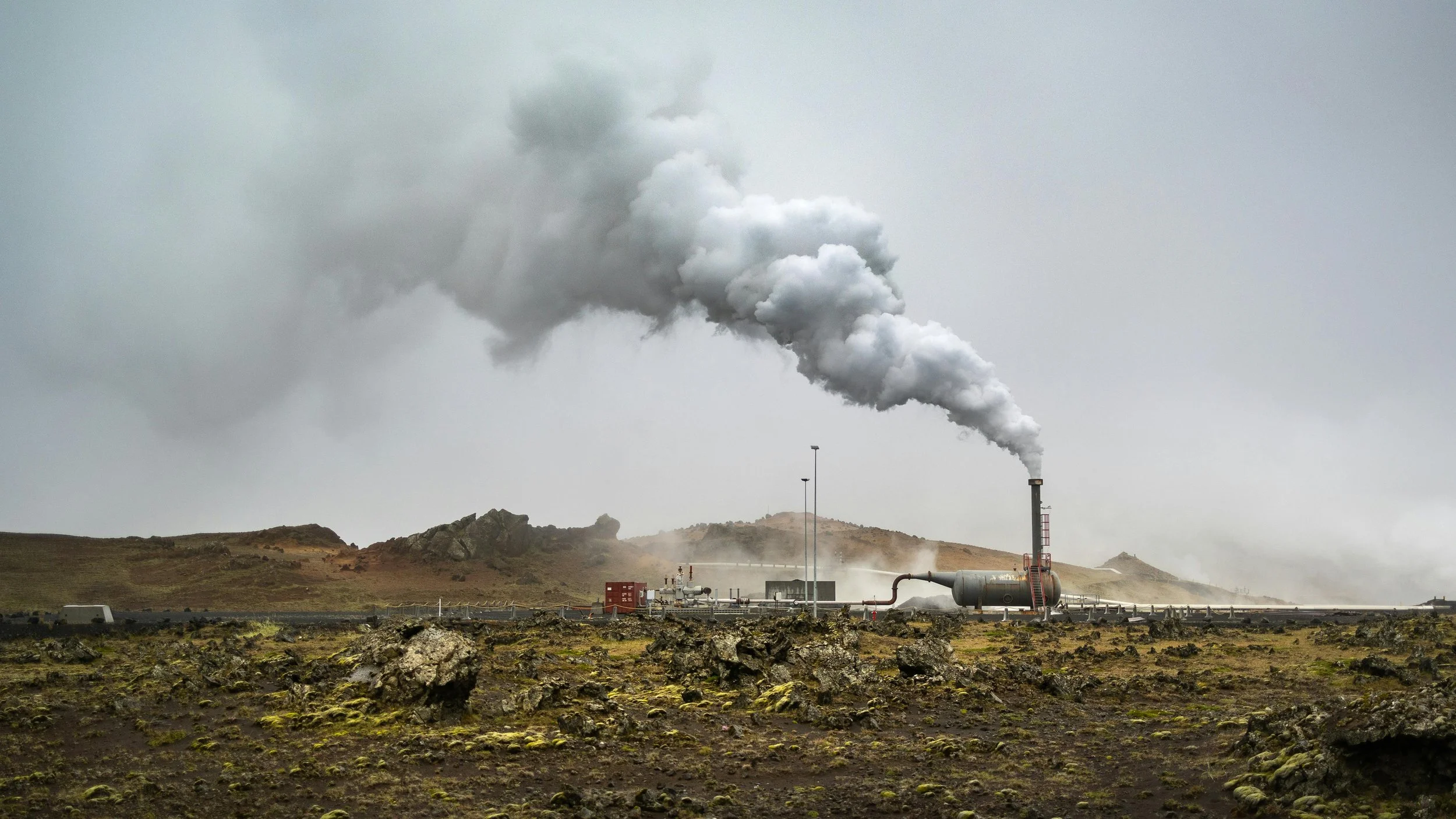 A Geothermal energy plant operating on a rocky landscape.