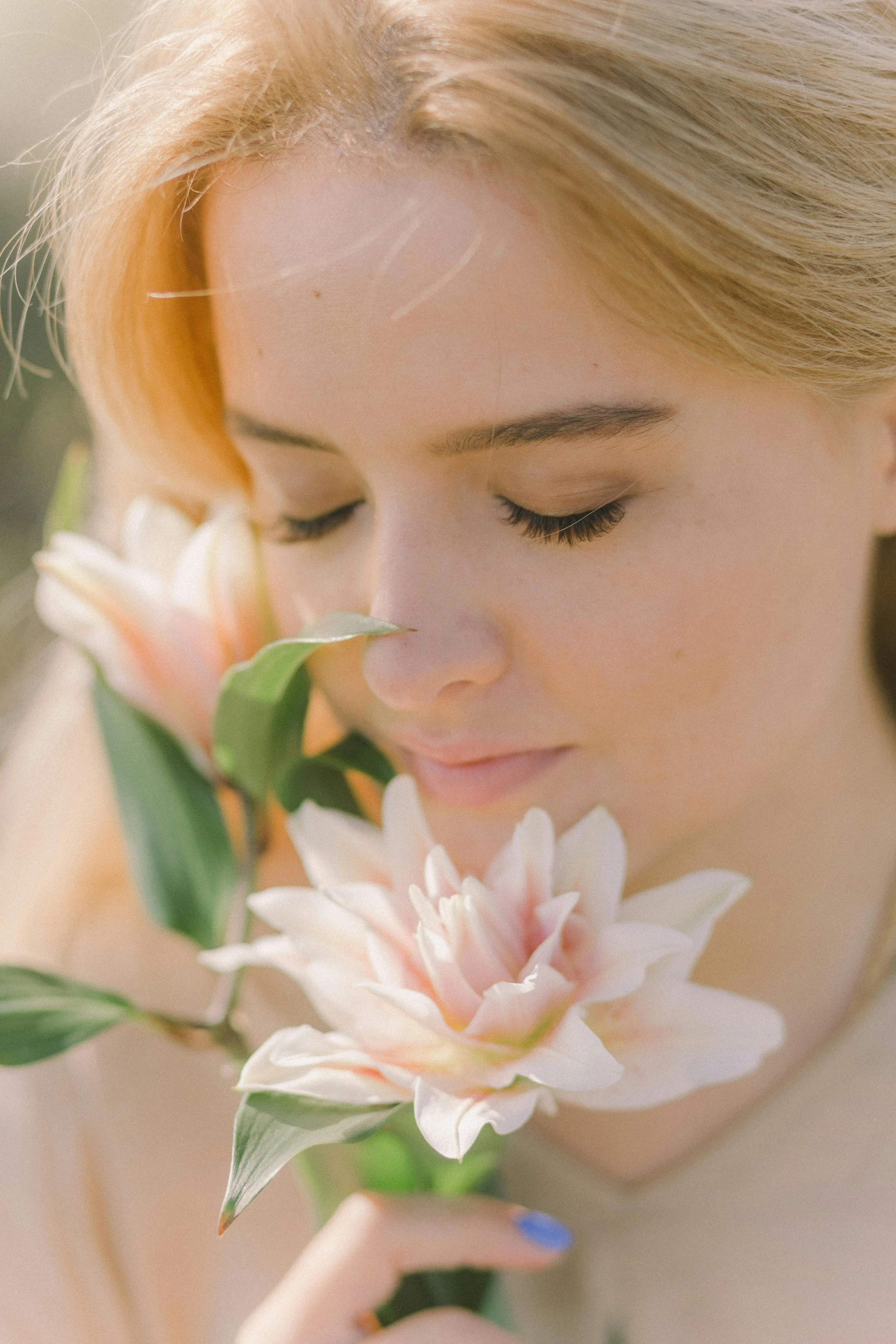 woman smelling flowers, glo2 facial near me