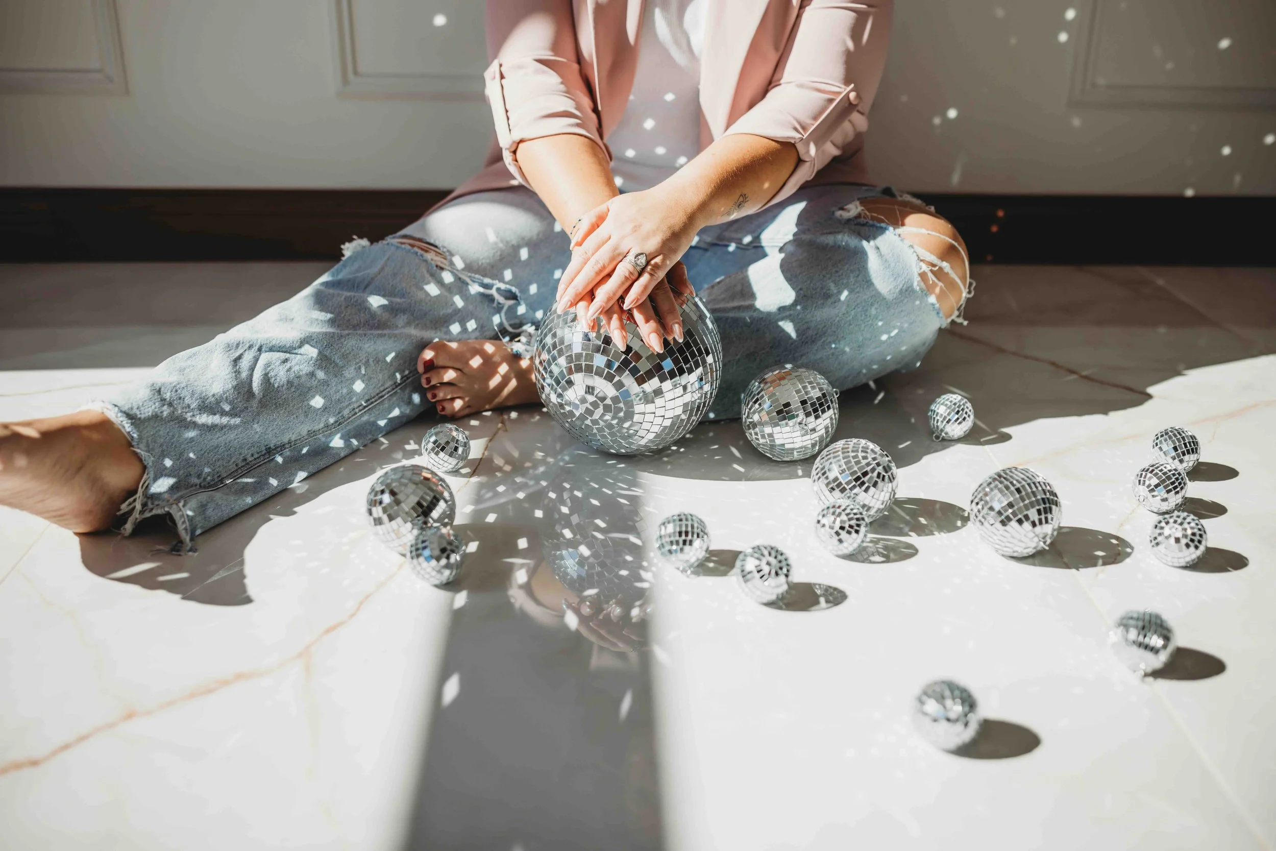 woman holding disco balls, glo2 facial geneva, IL