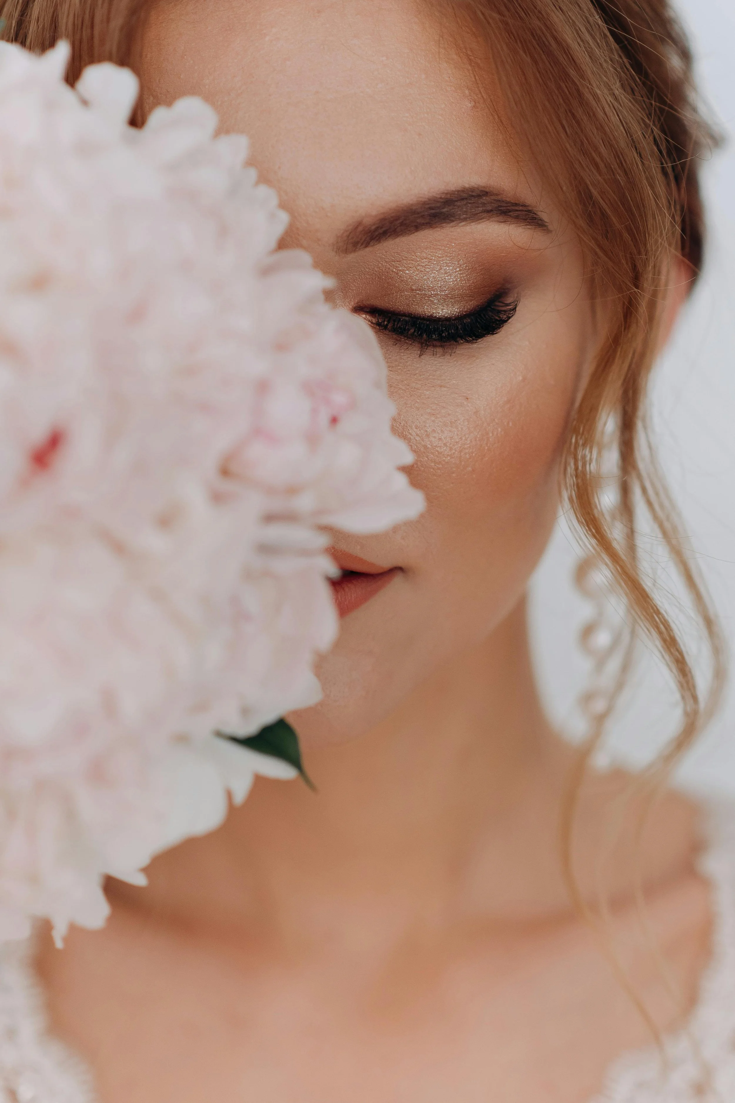 woman holding a flower; facials and waxing near me