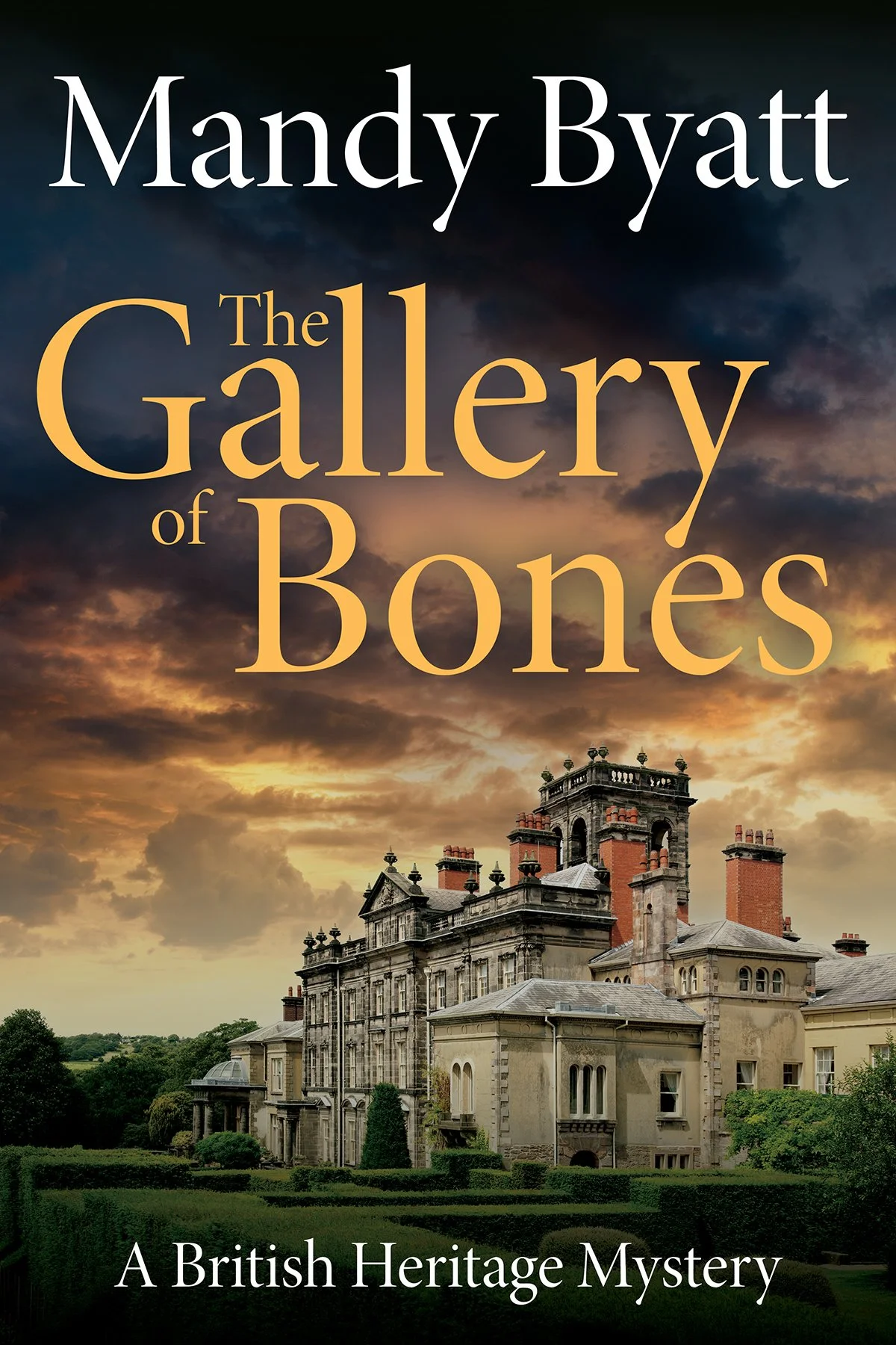 Book cover titled 'The Gallery of Bones' by Mandy Byatt, depicting an old estate mansion against a dramatic sunset sky with clouds, and the subtitle 'A British Heritage Mystery'.