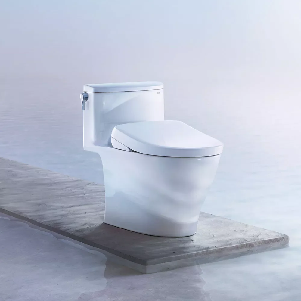 A modern white toilet, the brand being Toto toilets