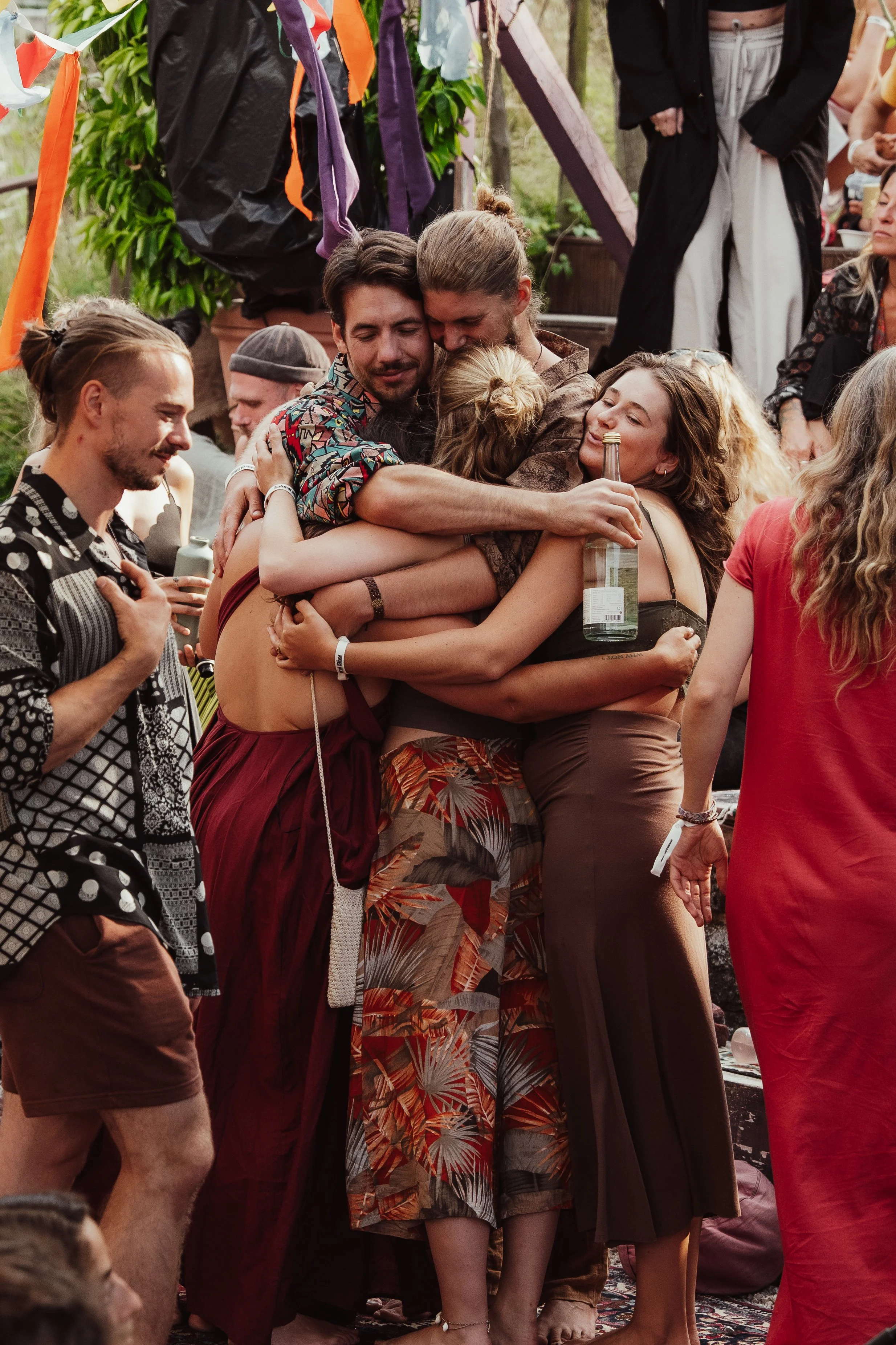 Menschen, die sich herzlich umarmen und bei einer Feier oder einem Fest lachen.