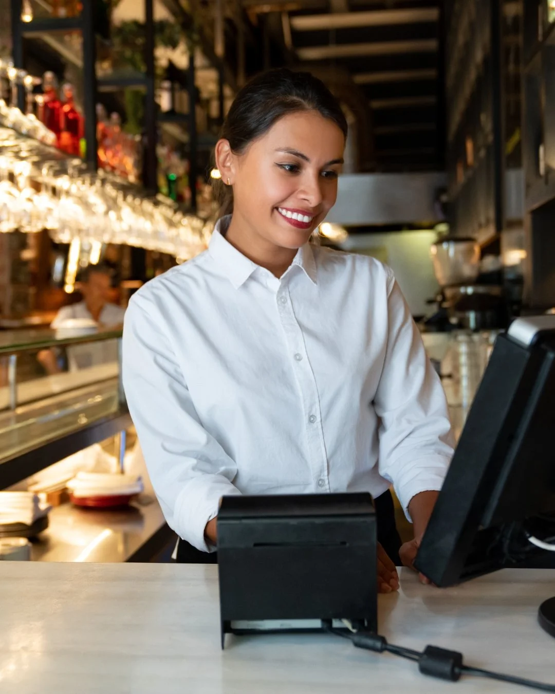 Woman in restaurant at computer taking order