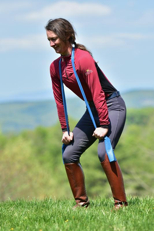 Horseback rider exercising to strengthen and stablelize core. 