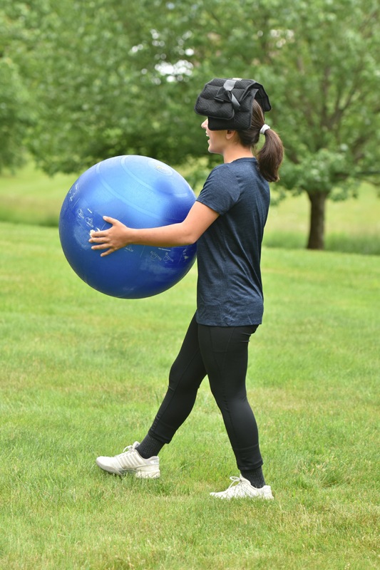 Horseback rider practicing body alignment with exercise ball.