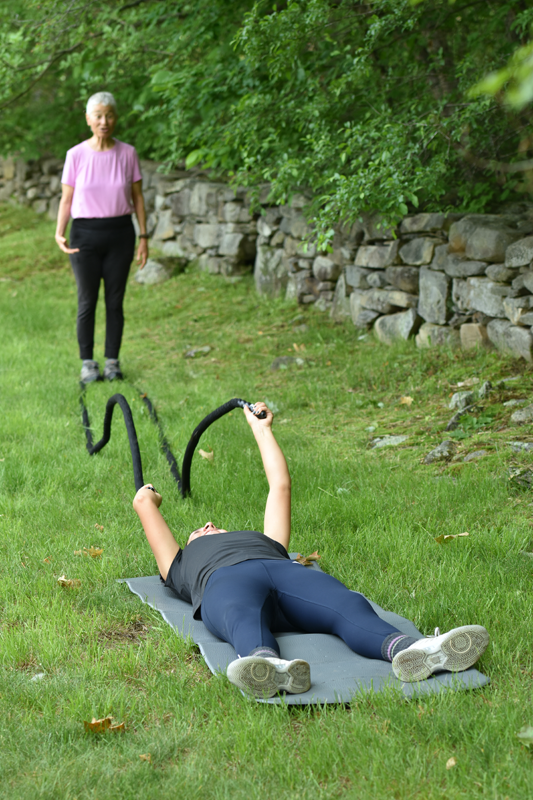 Horseback rider using battle ropes to strength core.