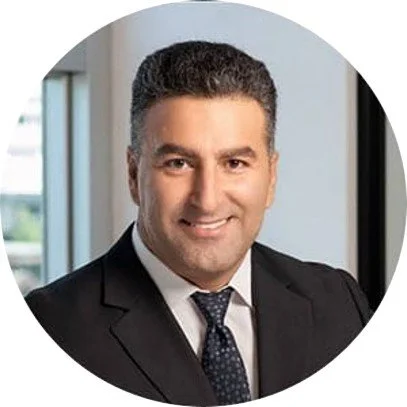 Portrait of Erez Tetro, CEO of VVT Medical. He is a smiling man in a suit and tie, standing indoors near a window.