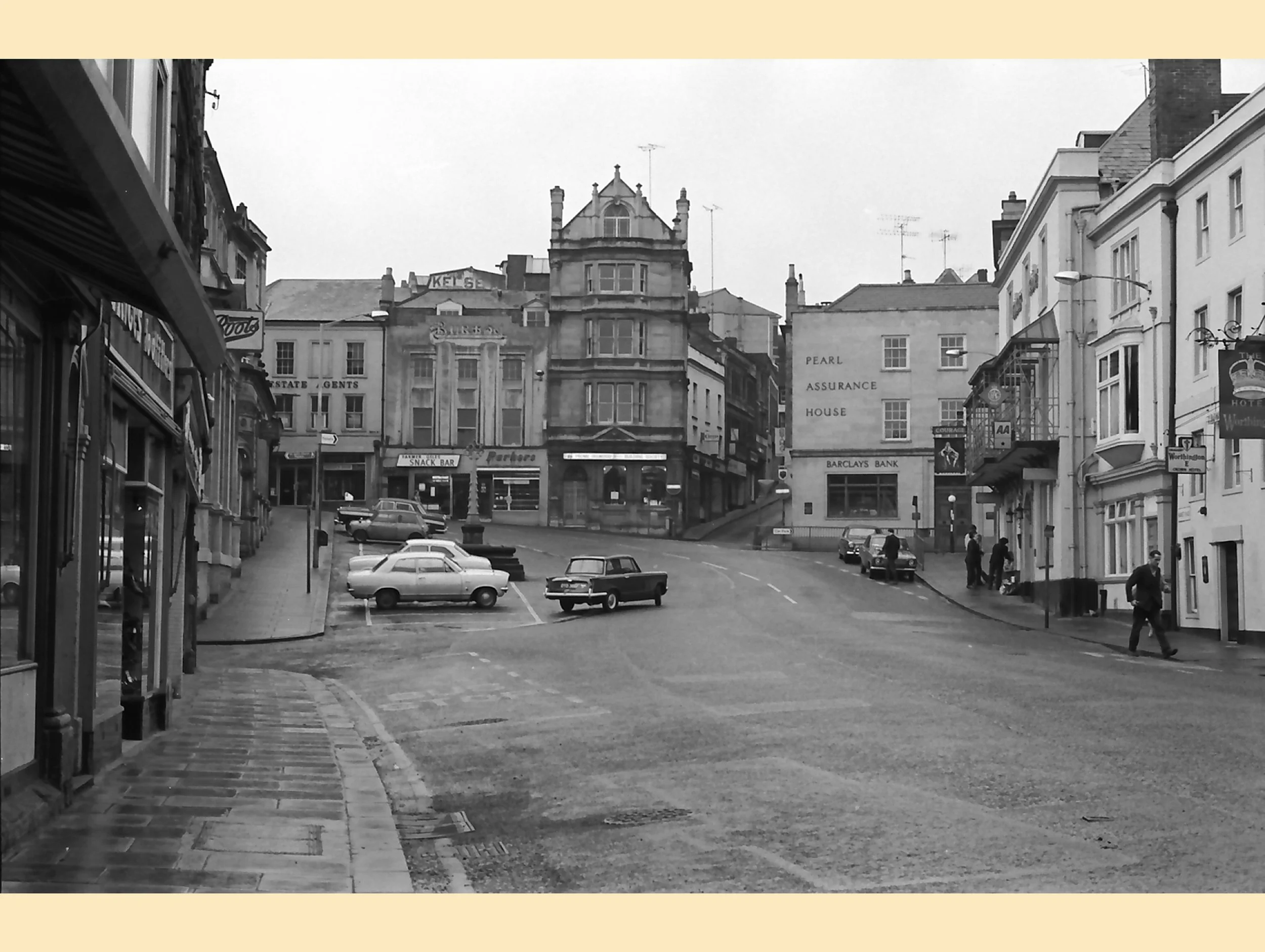  FROME MARKET PLACE -  
This 1970's photo shows a few differences from today, notably fewer cars and the normal pavement width, allowing busses to stop without impeding the flow of traffic.
