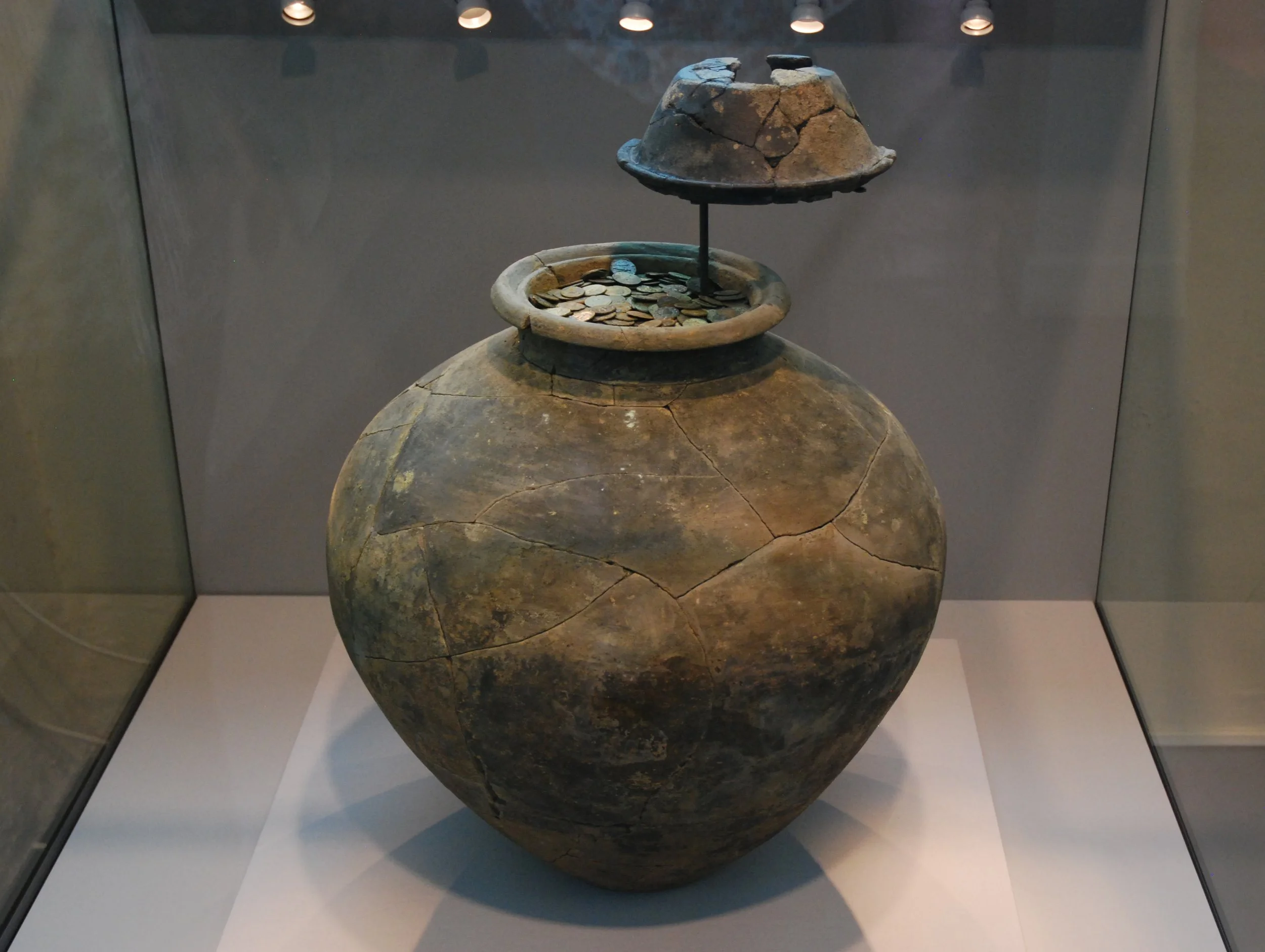  FROME HOARD -  
In 2010 Dave Crisp discovered a hoard of over 52000 Roman Coins in a fragile pot in a field near Witham Friary dating between 253 and 305. They are currently housed in Taunton Museum.
