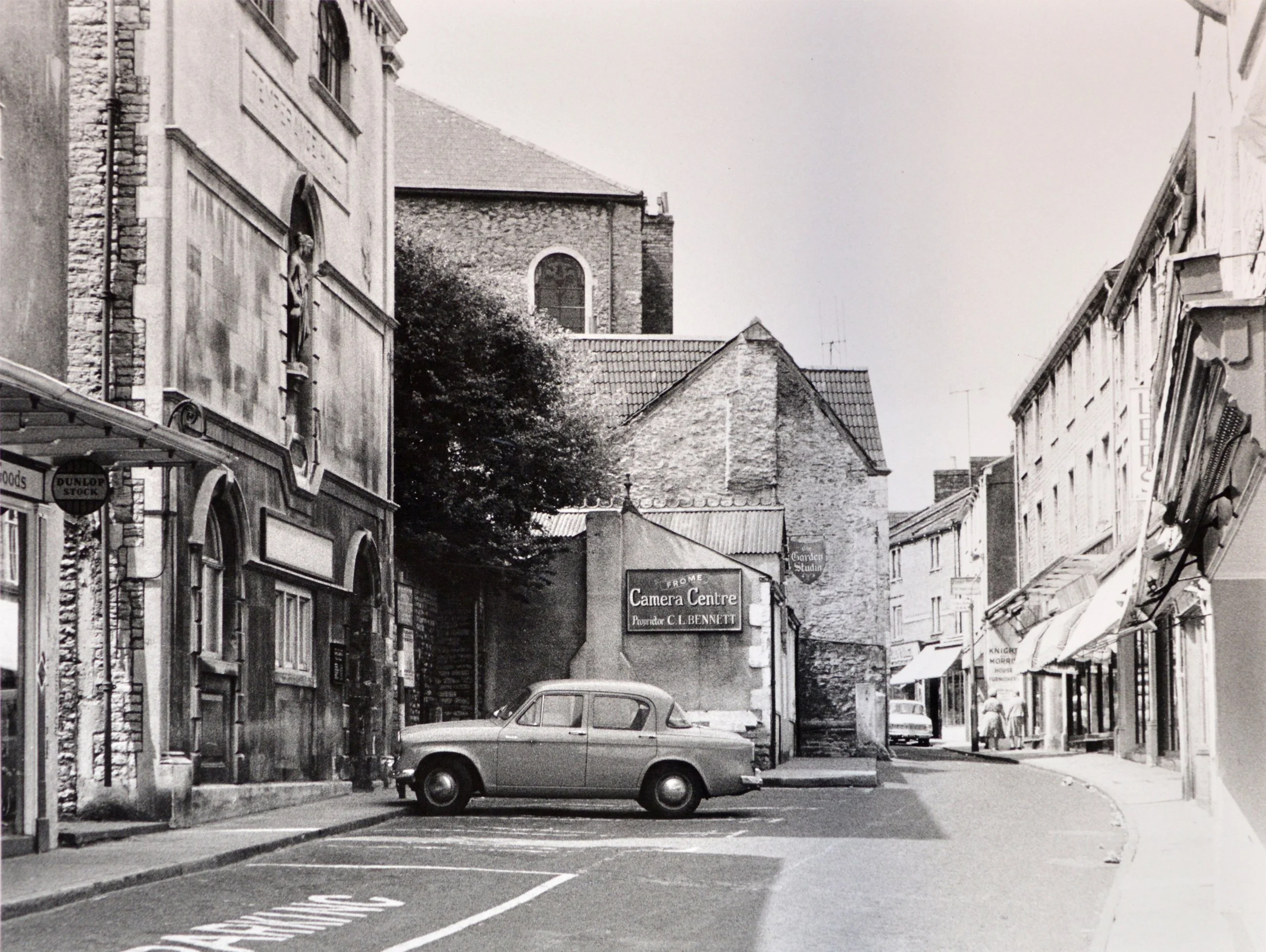  CATHERINE STREET -  
The building on the left is the Temperance Hall which was deemed unsafe and demolished in 1964. It is now a tiny car park. Frome Camera Centre was also demolished and in its place is the Valentine Lamp.
