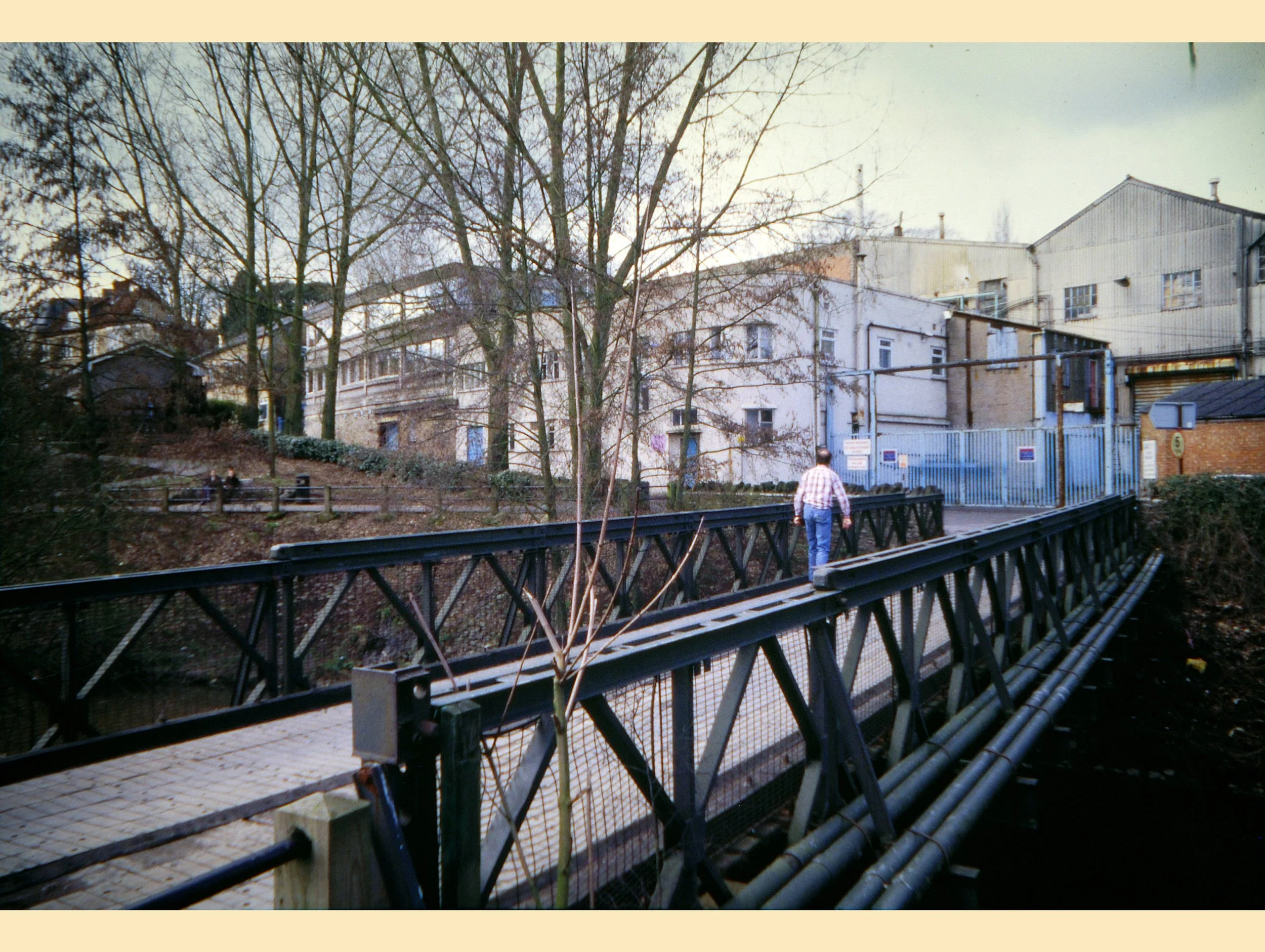  BAILEY BRIDGE -  
The Bailey Bridge took pedestrians and cars from the Market Yard car park across the river towards JW Singer’s factory. It became unsafe and was eventually replaced in 2011 with a pedestrian only walkway named Button Bridge in hono