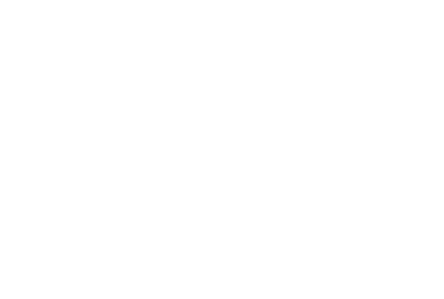 A computer monitor on a desk displaying a graph or chart with a person sitting in a modern office environment.