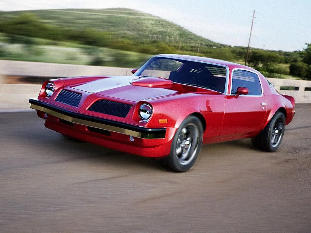 A red vintage sports car with a sleek, aerodynamic design driving on a highway in a rural area with green hills in the background.