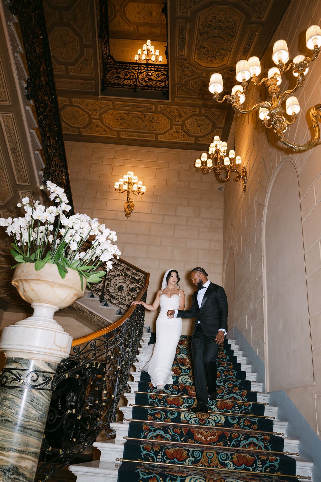 sarapaolucci-bride-and-groom-walking-down-the-stairs-of-stregis-hotel-in-rome.jpg