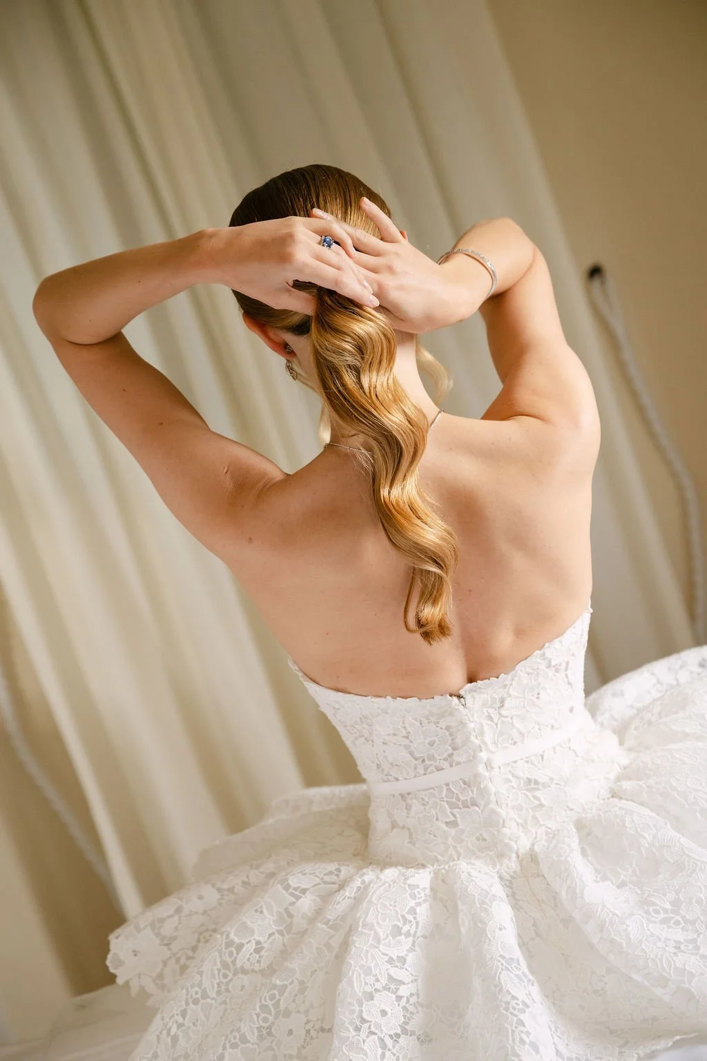 sarapaolucci-bride-fixing-her-ponytail.jpg