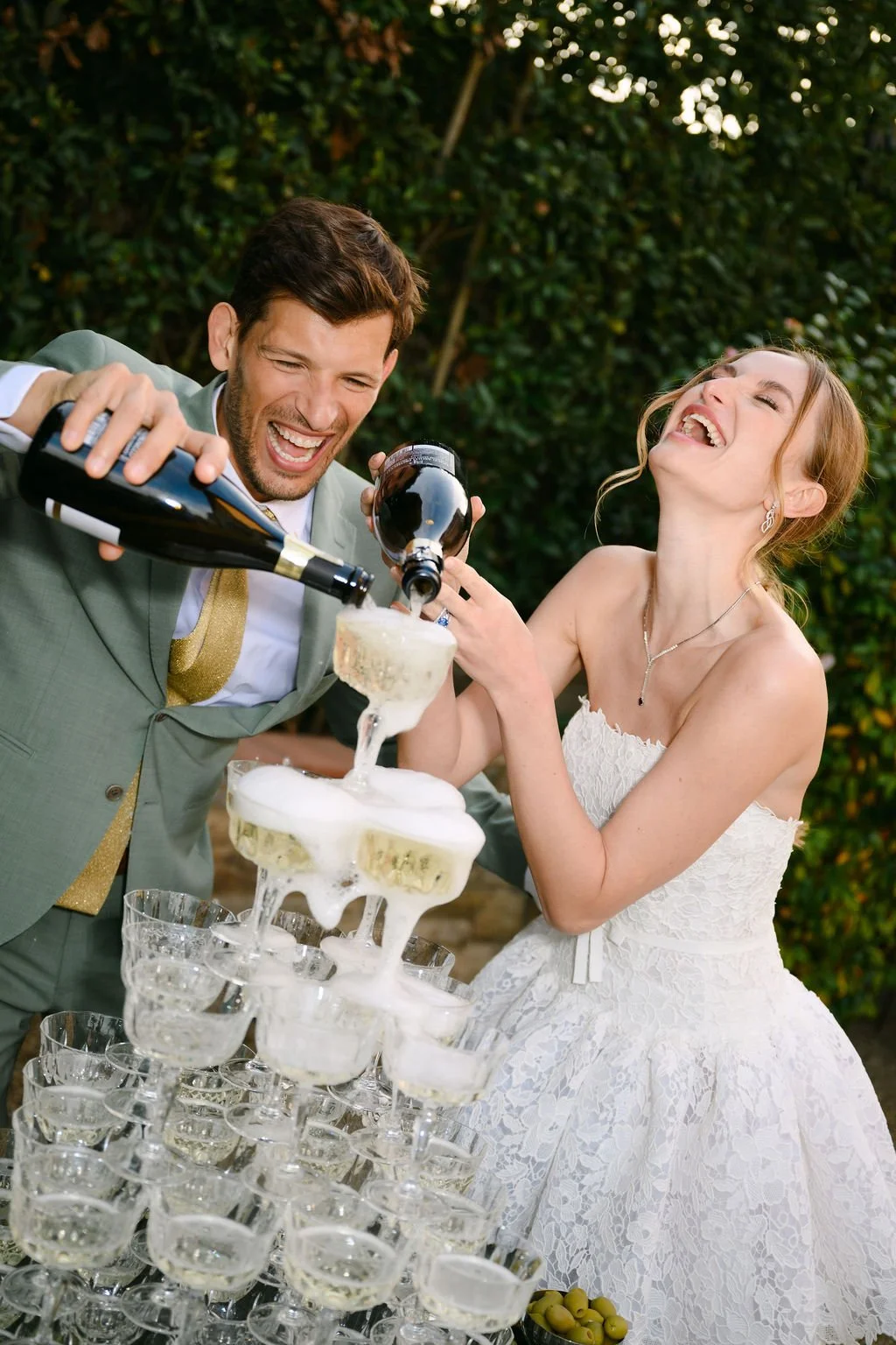 sarapaolucci-bride-and-groom-pouring-champagne-on-champagne-tower.jpg